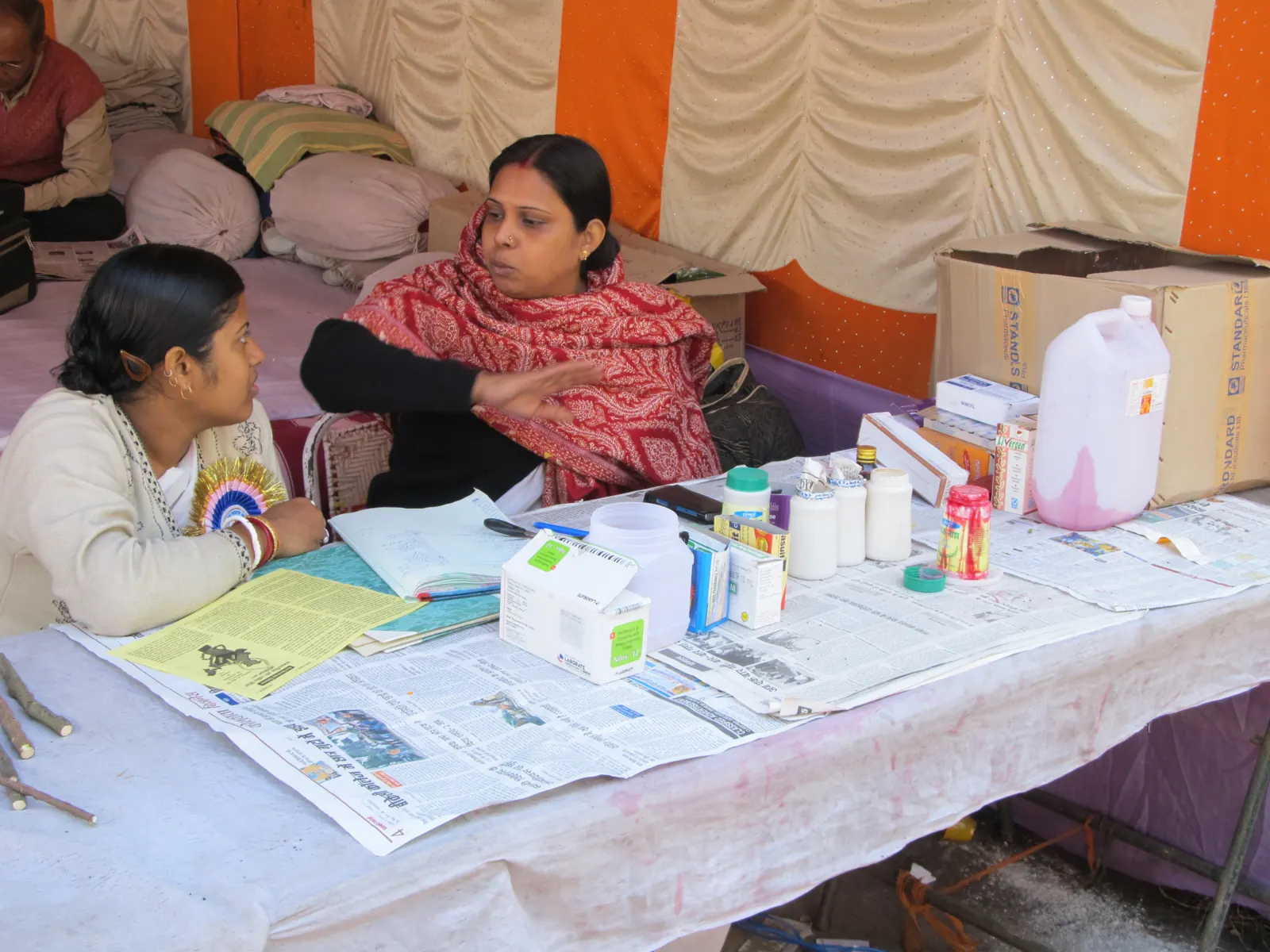 Volunteers and a doctor at a free health camp desk with medicines