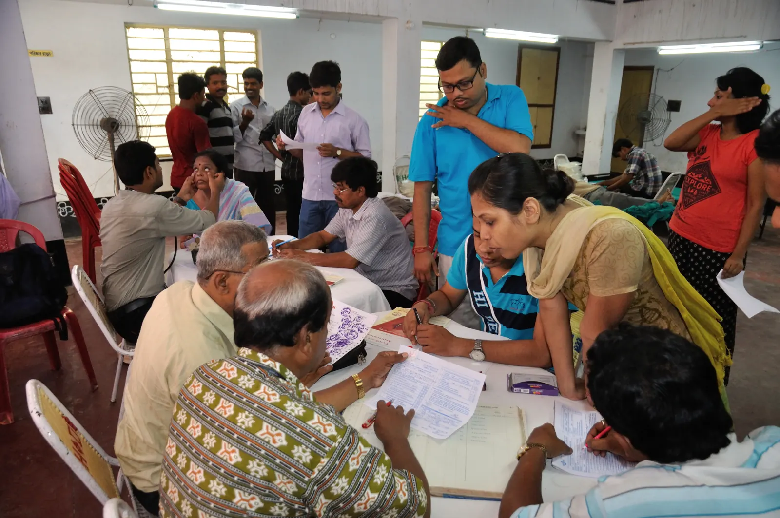Elderly people being registered and examined at a health camp