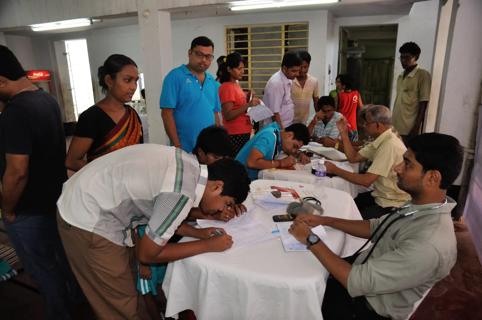 Volunteers registering patients at a free health camp